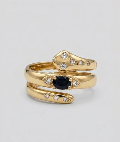Anello in oro giallo 18K a foggia di serpente con zaffiro blu e diamantini